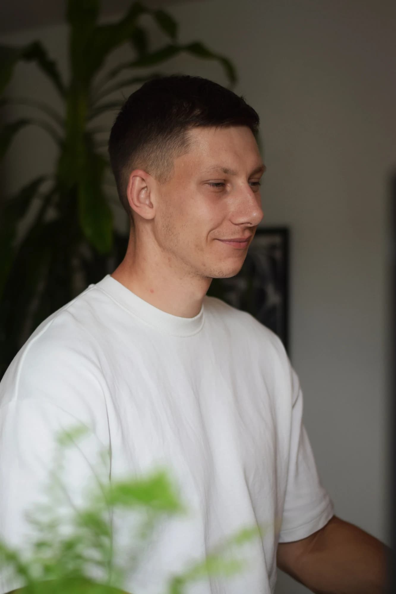 Jurica Stublić in his office, in a white T-shirt, looking to the side